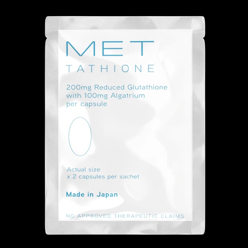 Close‑up of a single Glutathione sachet opened to reveal capsule powder