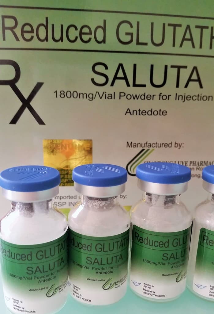 Glutathione capsules beside fresh fruits representing antioxidants