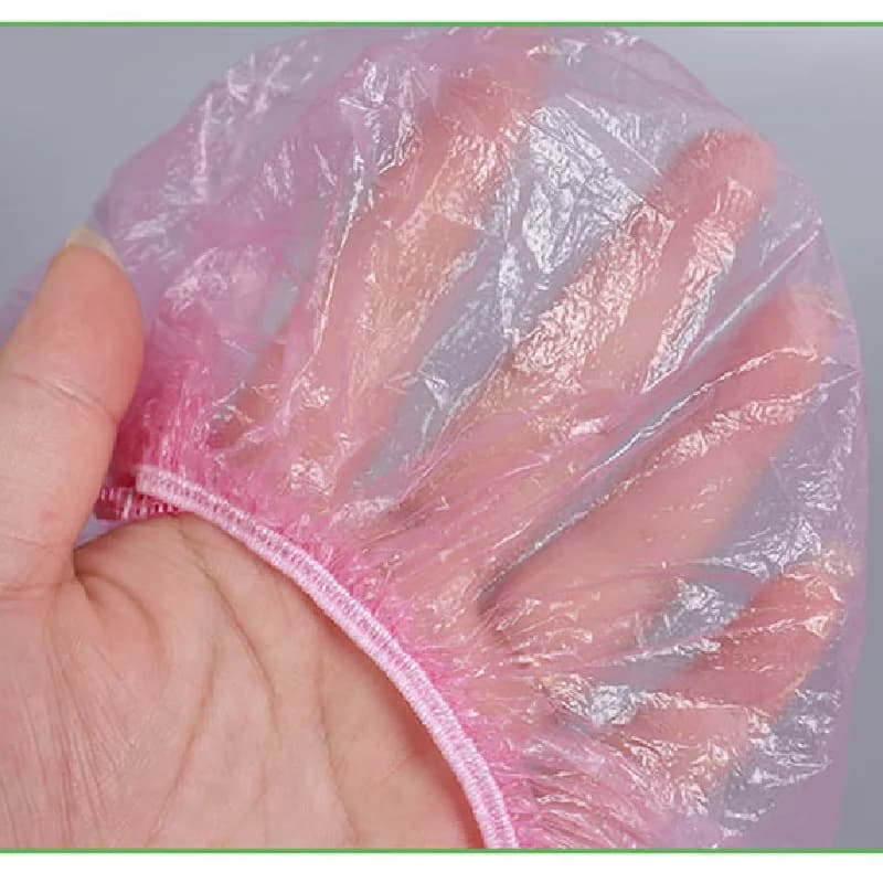 Disposable plastic shower hair caps in pink — image 4