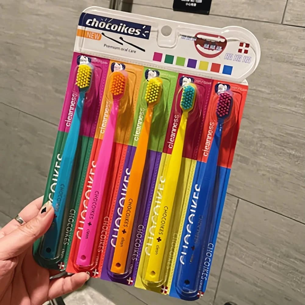 Five soft pastel toothbrushes in a travel case — image 1