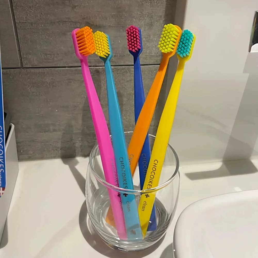 Five soft pastel toothbrushes in a travel case — image 6