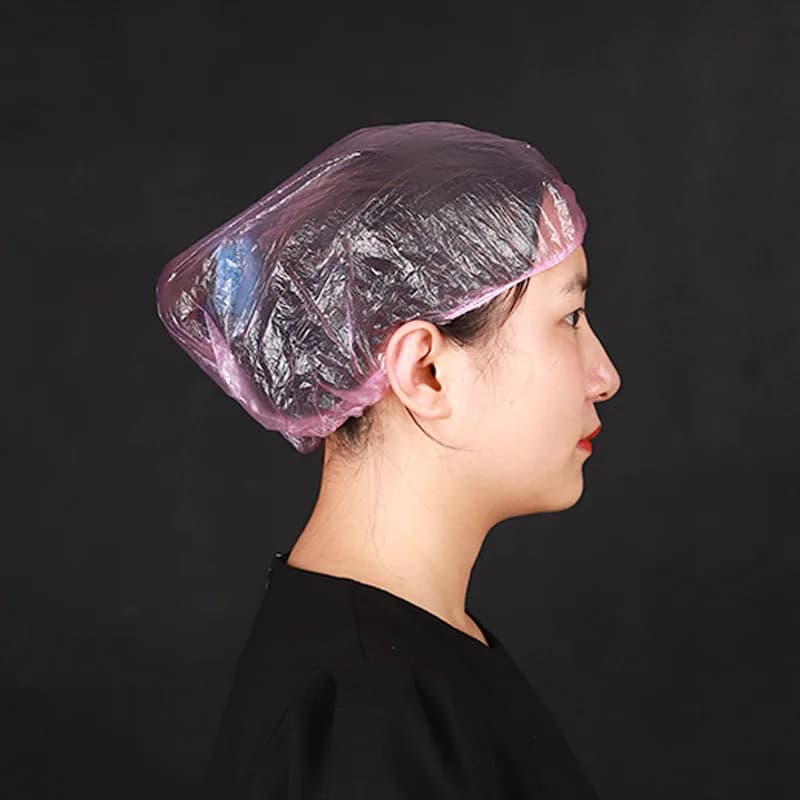 Disposable plastic shower hair caps in pink — image 2